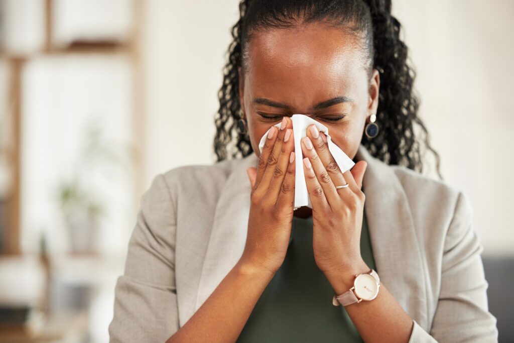 Blowing nose, business and sick black woman with tissue for hayfever, allergies and flu symptoms. H